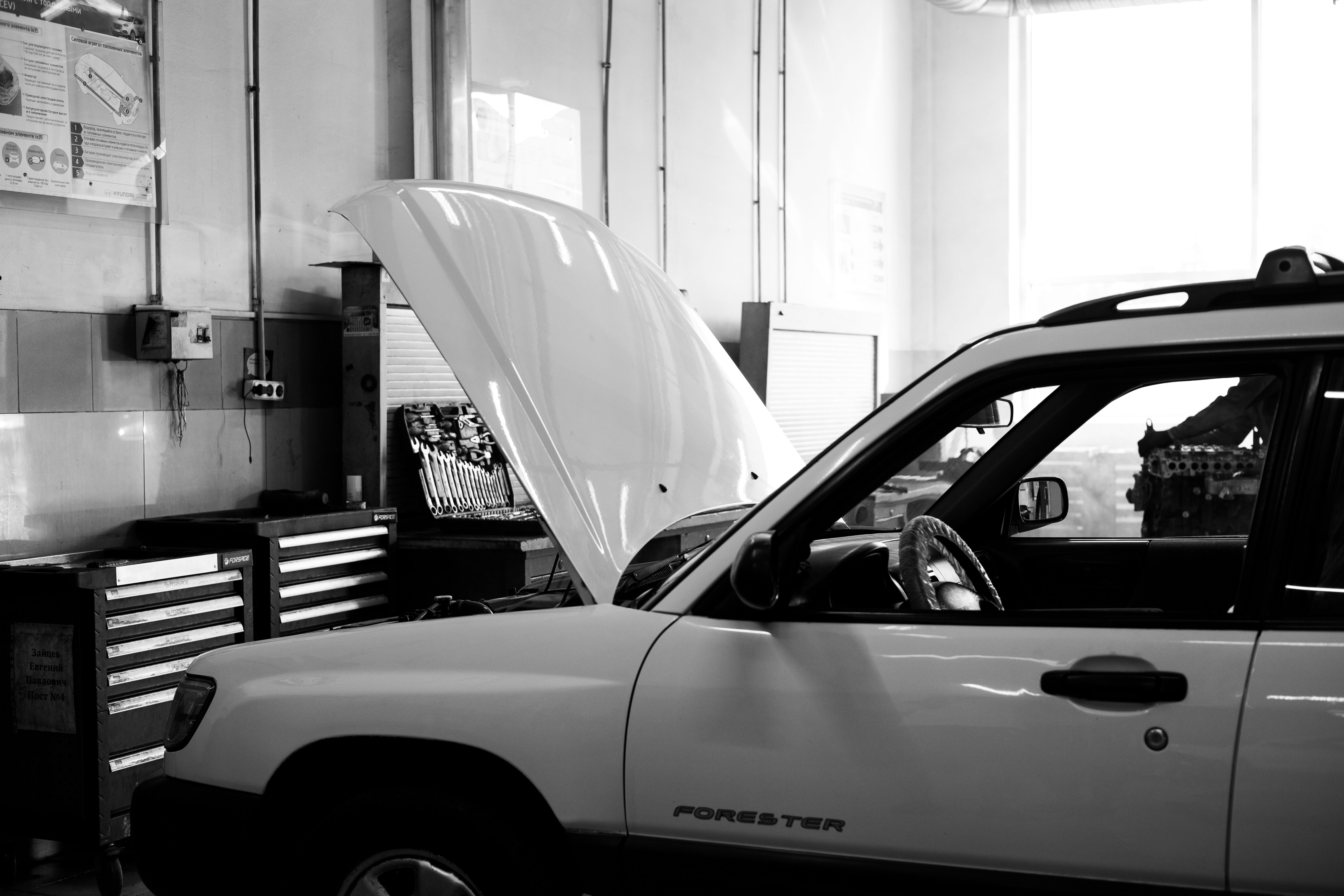 Technician performing detailed vehicle inspection